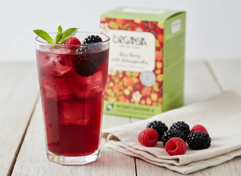 Iced Very Berry cooler with fresh berries and Organsia Very Berry with Ashwagandha carton