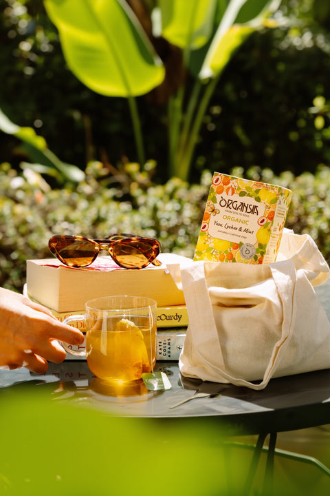 Organsia Yuzu Lychee & Mint iced tea in a summer garden